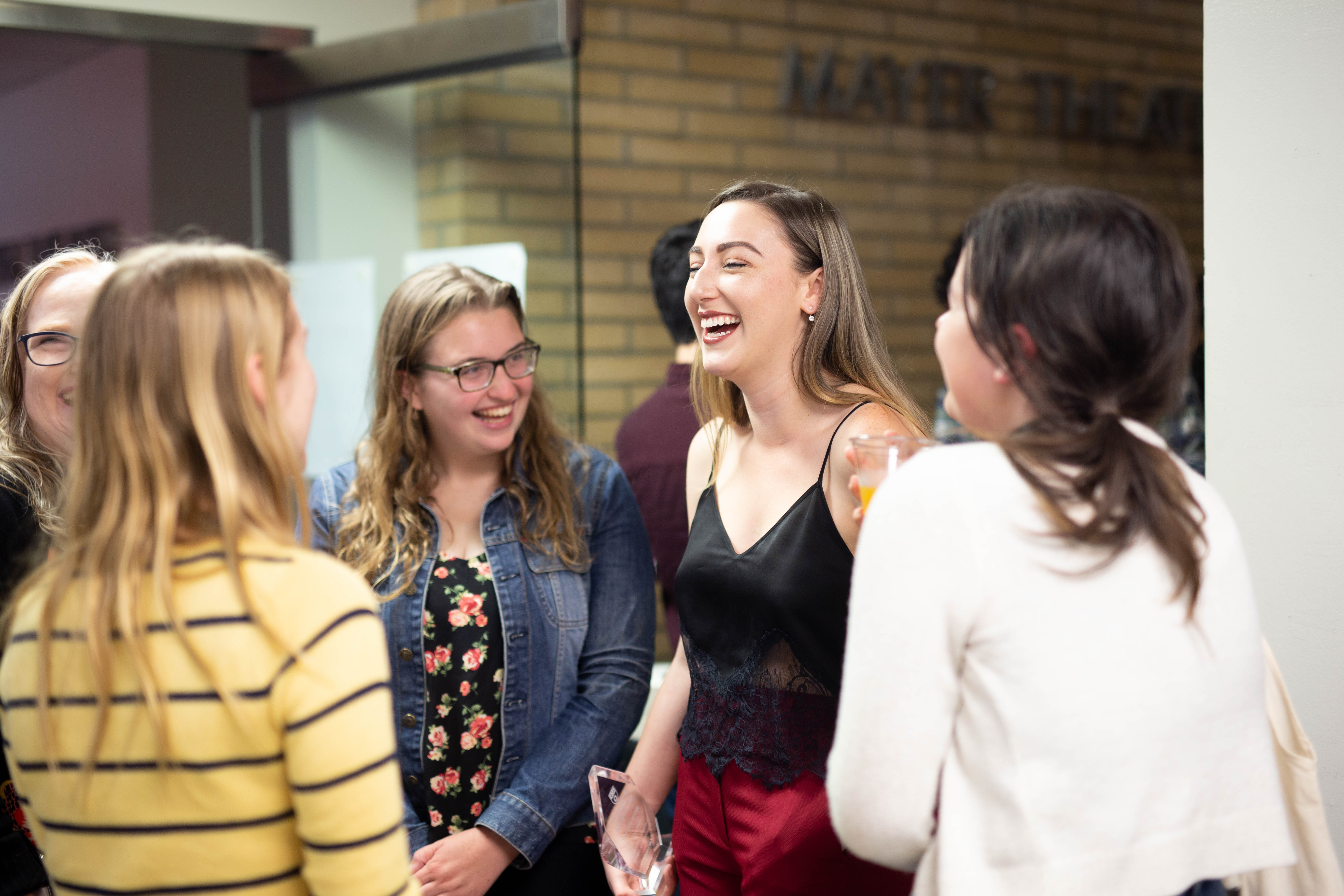 Group of students smiling and laughing together