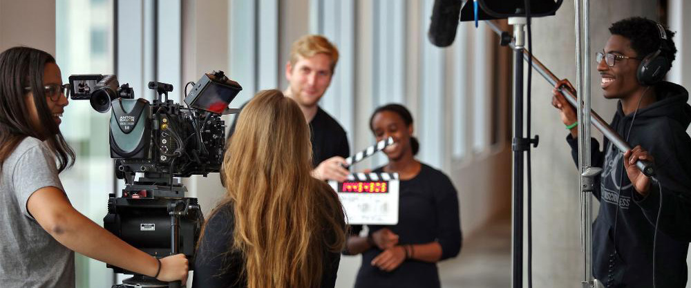 Students shooting a scene with a slate at the ready