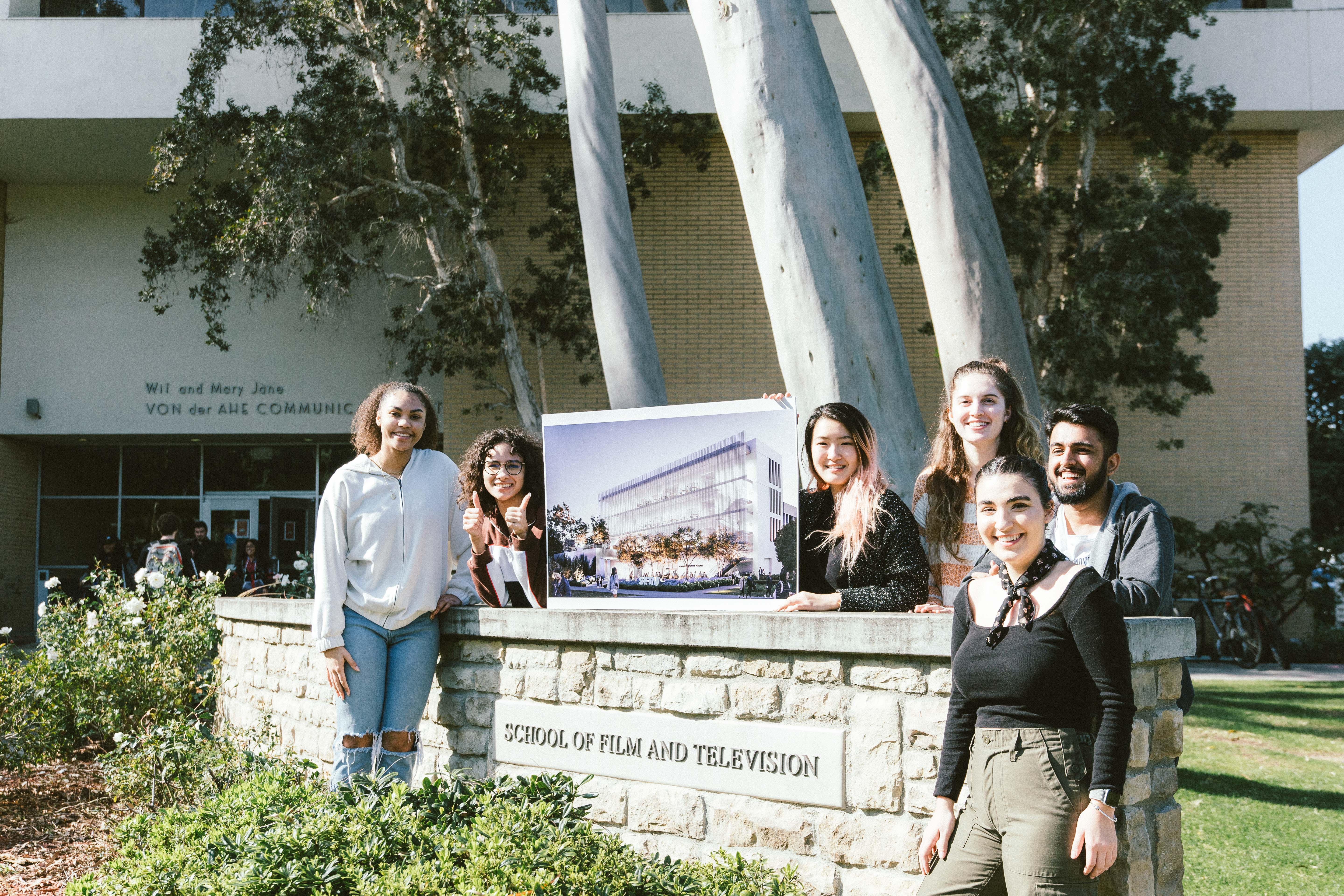 SFTV students hold up an image of the Pavilion outside