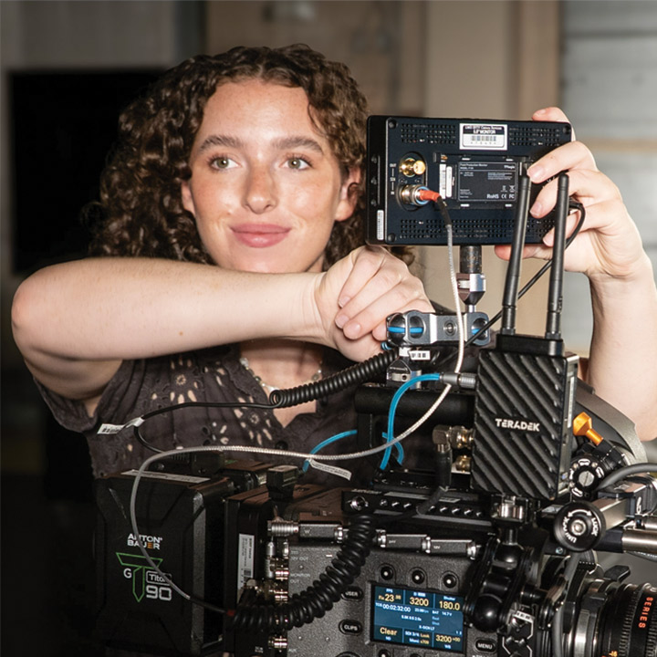 LMU SFTV student operating camera on set